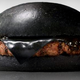Illustration for article titled Burger King's all-black burger looks absolutely disgusting in real life